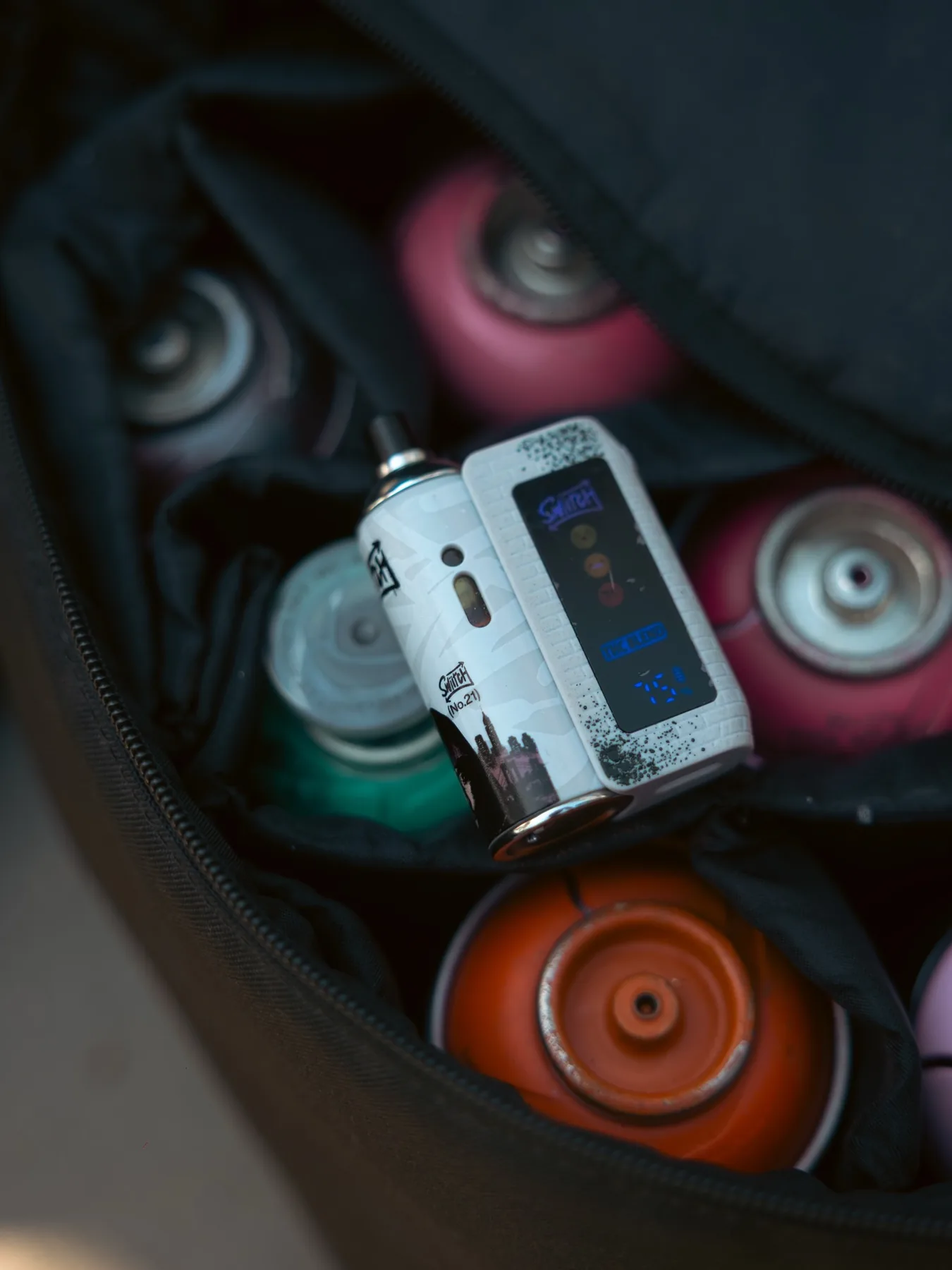SWIITCH device photographed with paint cans